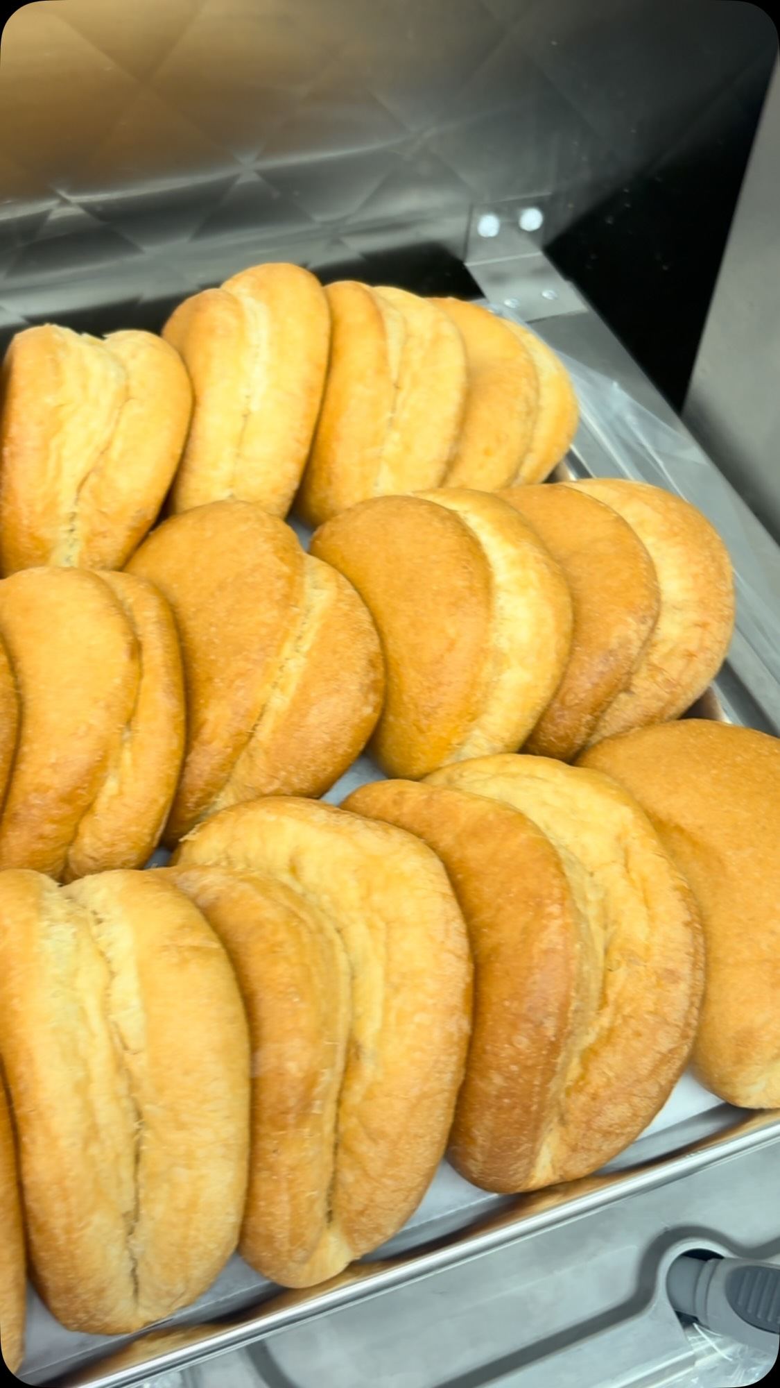 Tray of golden bread rolls