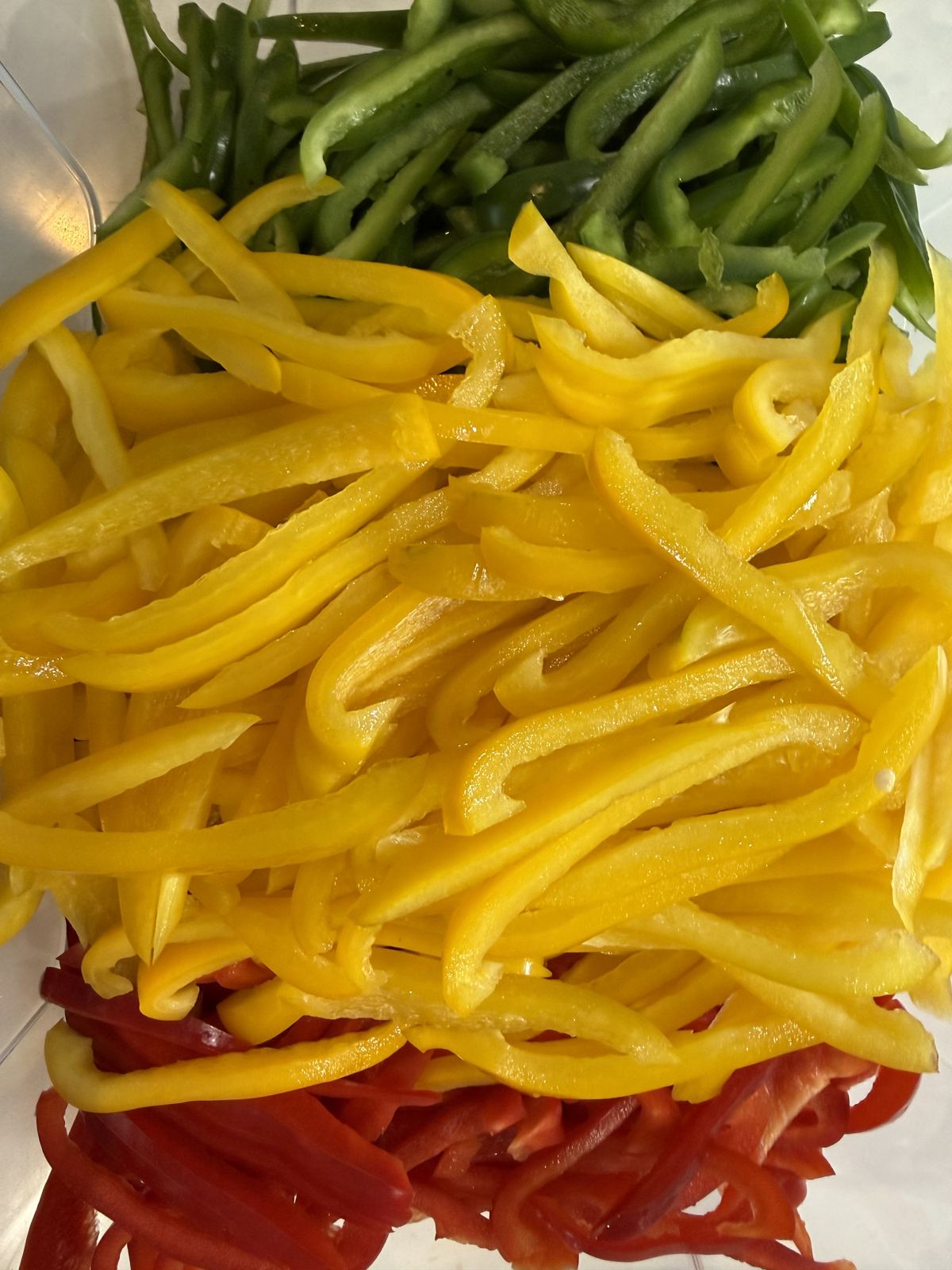 Fresh-sliced red, yellow and green peppers